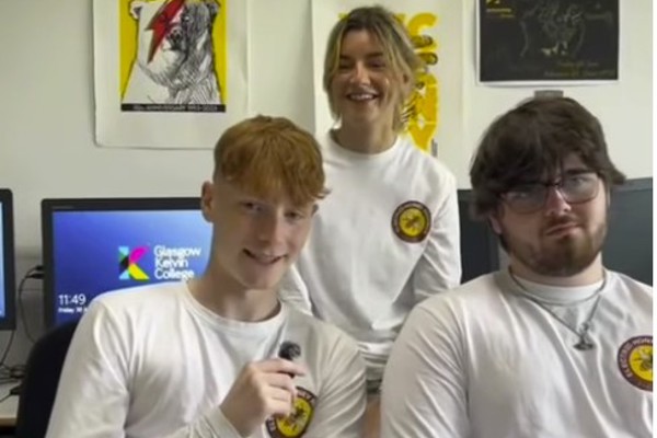 Three Glasgow Kelvin College Music Business students wearing Electric Honey Records shirts, smiling during a group video interview in a classroom.