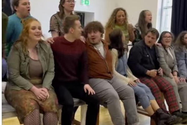 Vibrant group of Musical Theatre students rehearsing a dynamic scene from Rent at Glasgow Kelvin College.