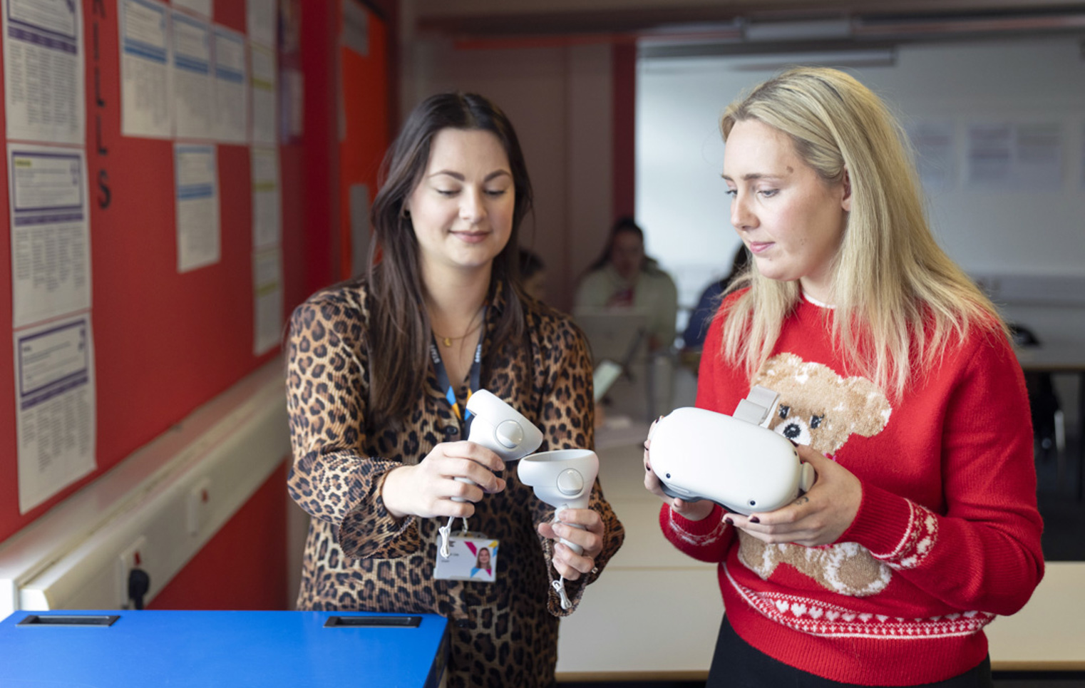 Lecturer and student examining virtual reality equipment during a lesson at Glasgow Kelvin College.