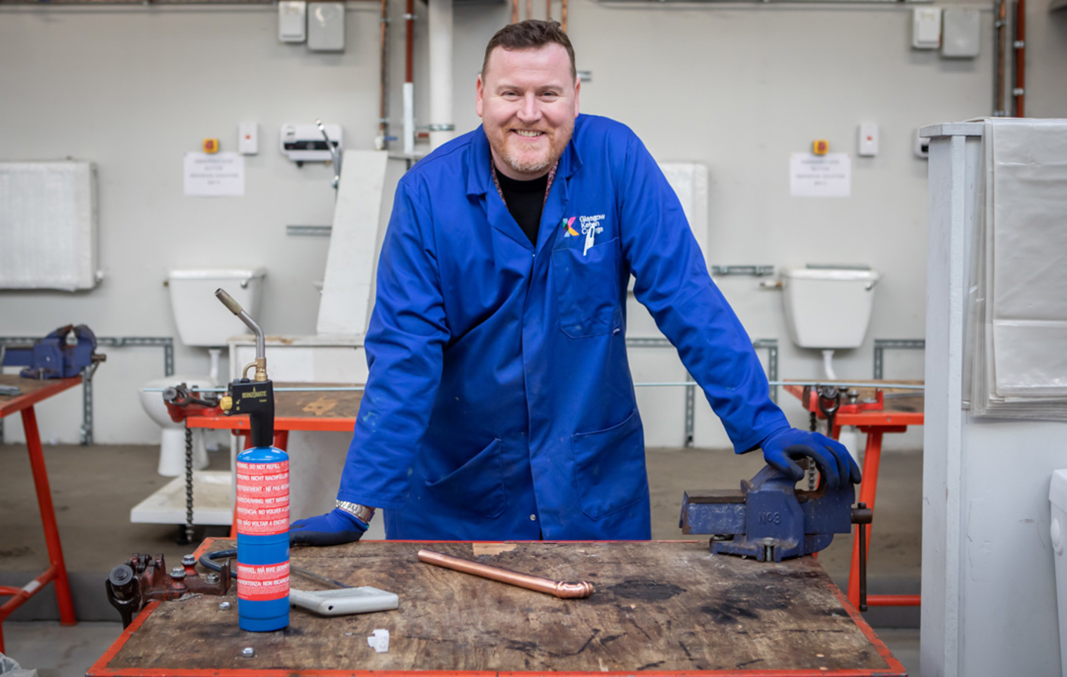 Plumbing lecturer in a practical workshop at Glasgow Kelvin College.