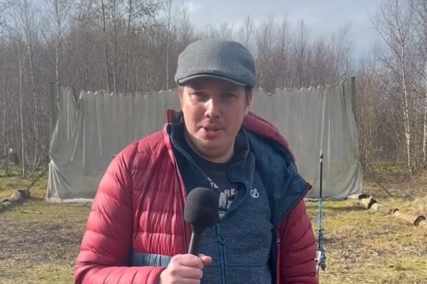 HN Adventure Sports student Steven speaking into a microphone during an outdoor activity session.