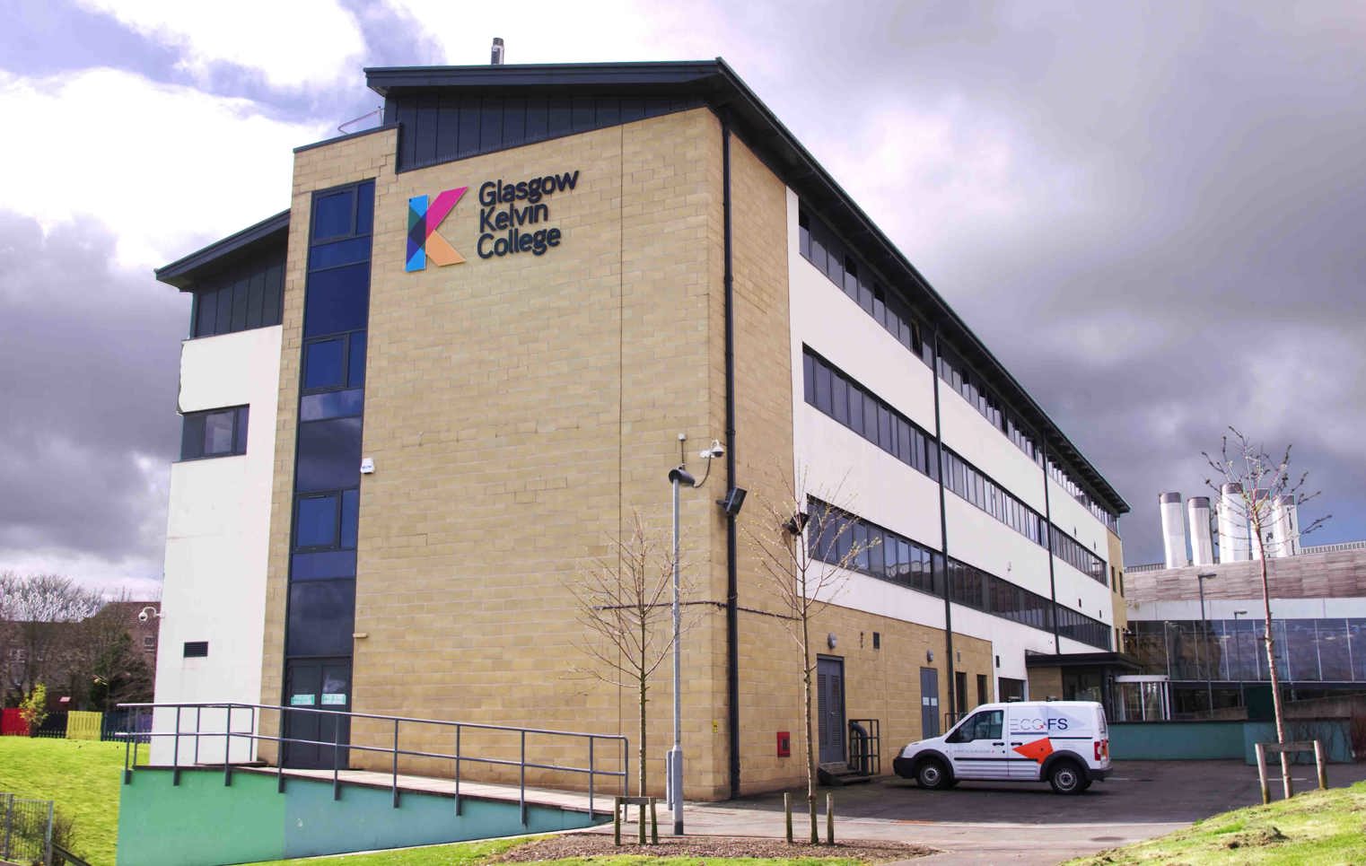Exterior view of Glasgow Kelvin College Easterhouse Campus, showing the modern building and surrounding landscape.