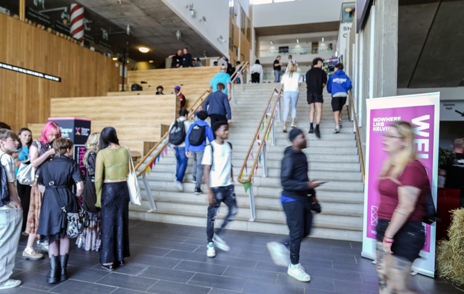 Students walking up the central staircase at Glasgow Kelvin College Springburn campus during a busy Open Day event
