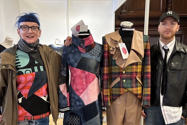 Glasgow Kelvin students Evy Craig and Craig Watson standing proudly beside their award-winning fashion designs at Craftex 2025.