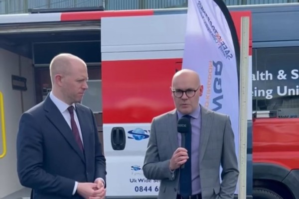 Assistant Principal of Glasgow Kelvin College being interviewed beside the College's rail engineering training vehicle during an engineering and rail partnership event.