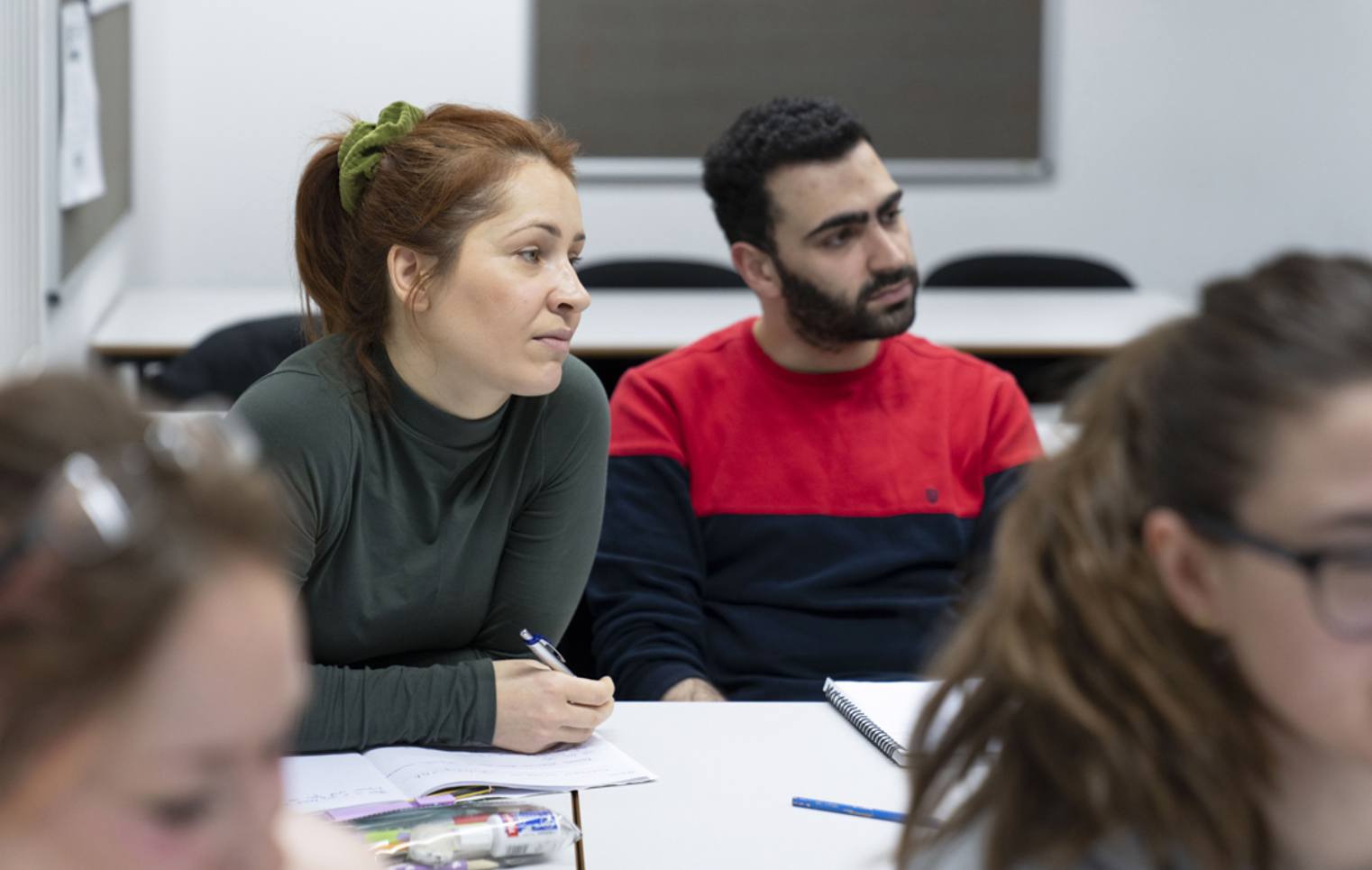 Two students listening intently during a humanities lesson at Glasgow Kelvin College