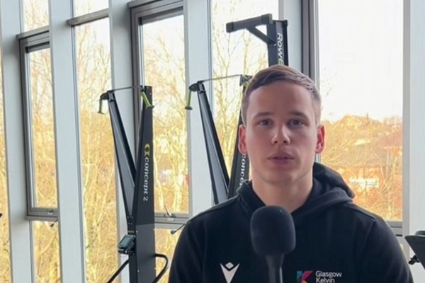 Sport student speaking into a microphone in a gym at Glasgow Kelvin College.