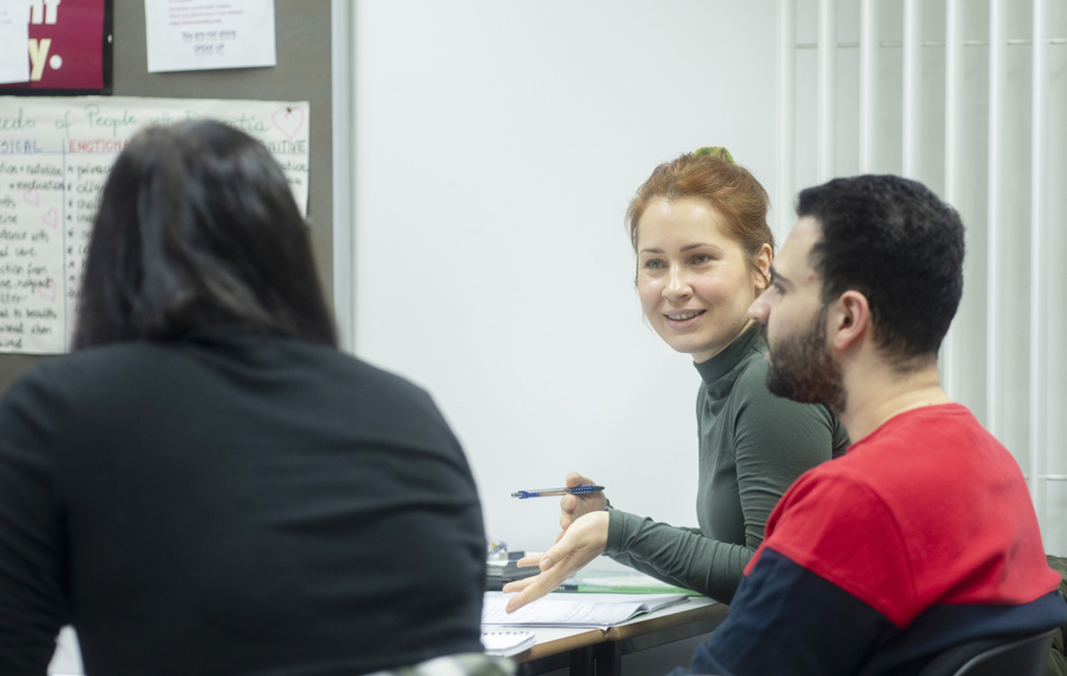 Students in discussion during a humanities class at Glasgow Kelvin College, sharing ideas and taking notes.