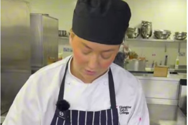 Hospitality student at Glasgow Kelvin College preparing a dessert in the kitchen during a practical cooking session.