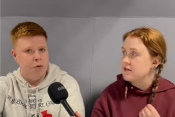 Two HNC Childhood Practice students from Glasgow Kelvin College, Brogan and Abbie, sitting together during an interview, holding a microphone and discussing their course.