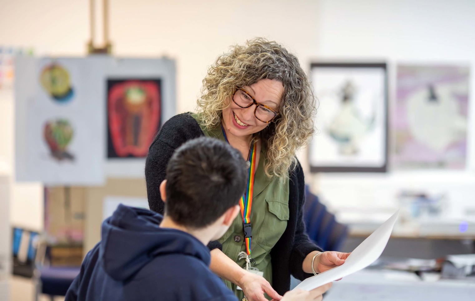 Art and Design lecturer supporting a student with their work at Glasgow Kelvin College.