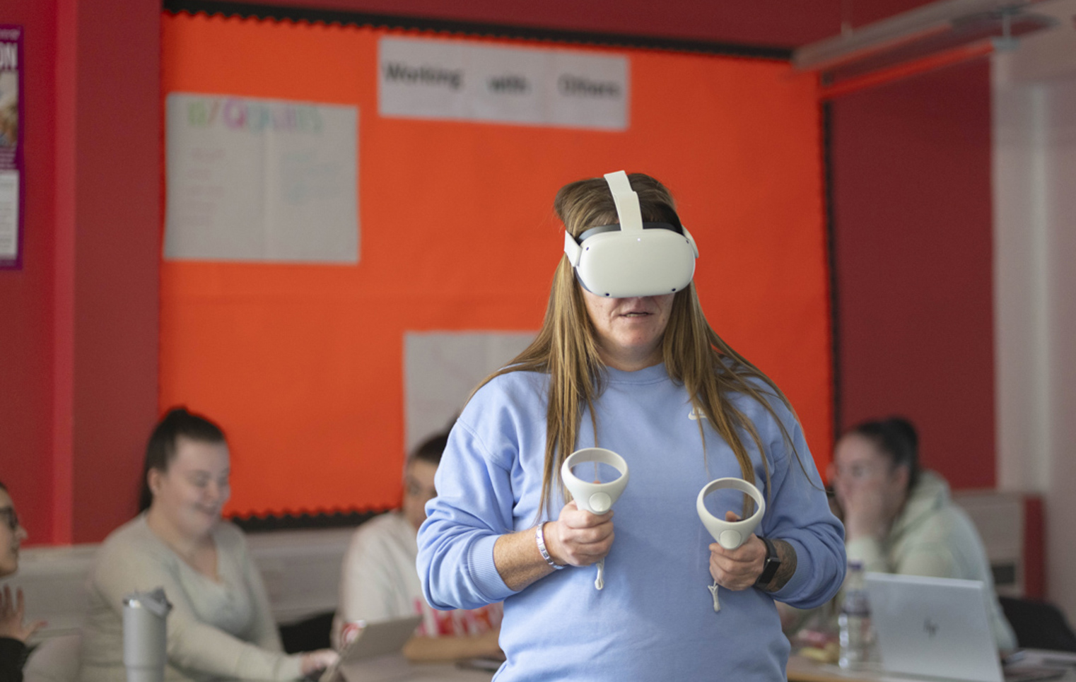 Student using a virtual reality headset and hand controllers during a learning activity at Glasgow Kelvin College.