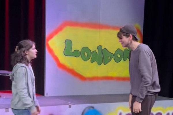 Acting and Performance students performing a scene on stage with colourful set design at Glasgow Kelvin College.